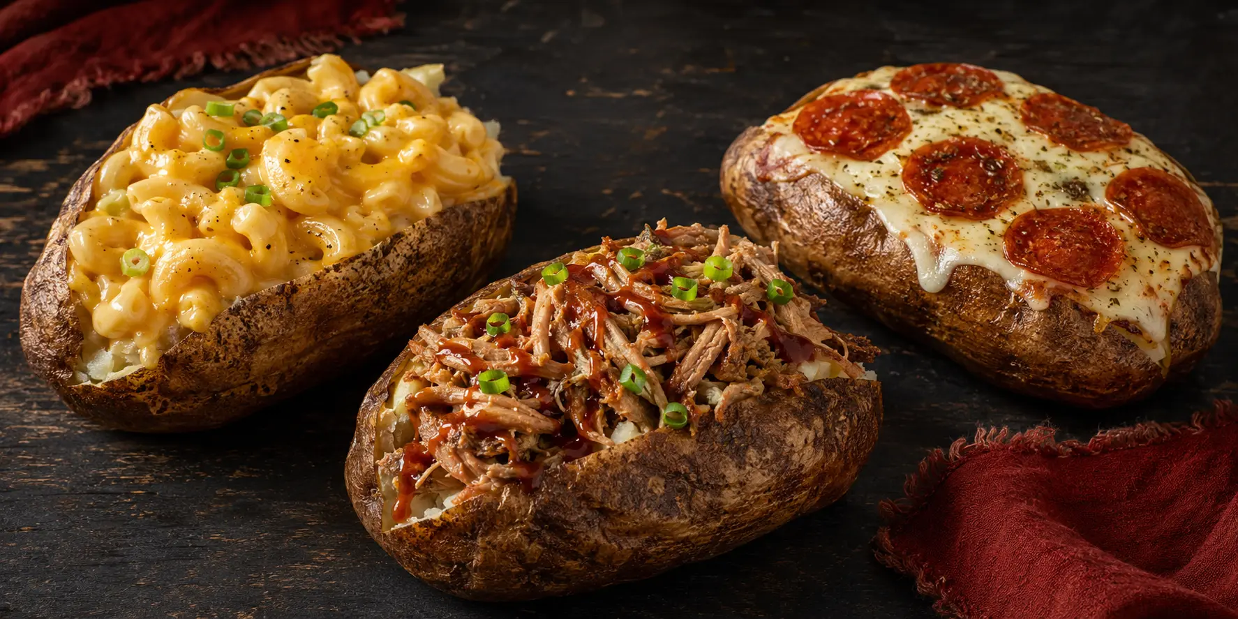Mac and cheese, pulled pork, and pepperoni pizza loaded baked potatoes